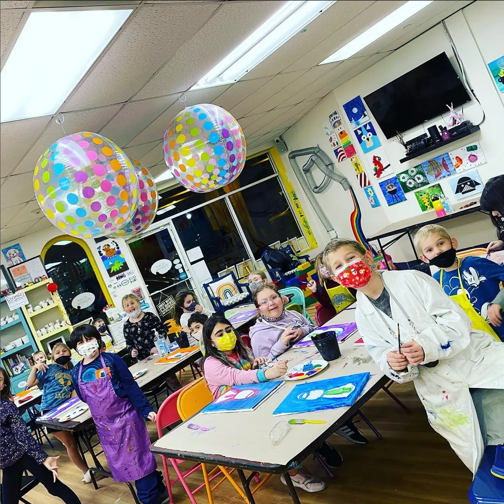 Kids in lab coats at an art lab science party